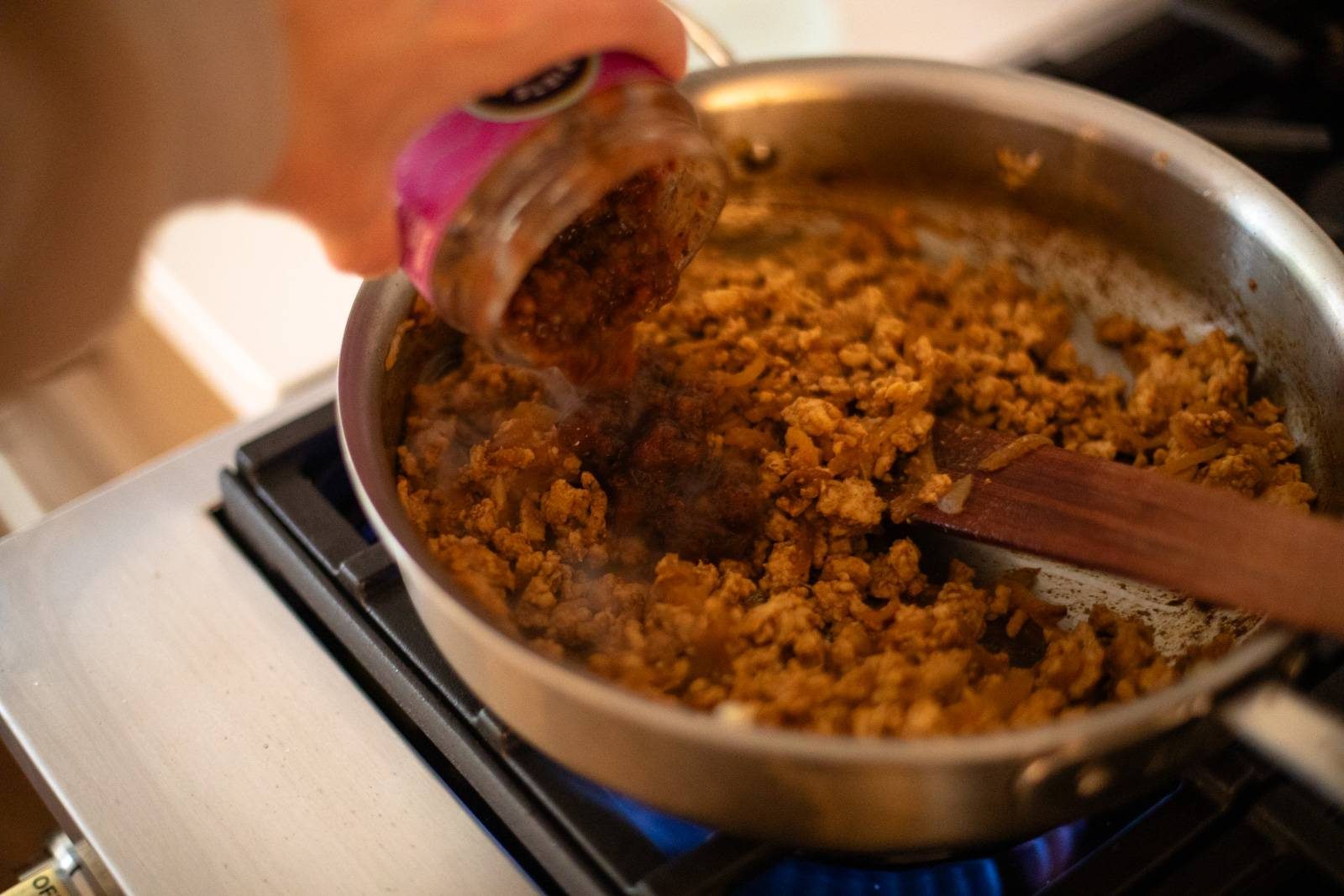 Ground chicken cooked in a skillet.