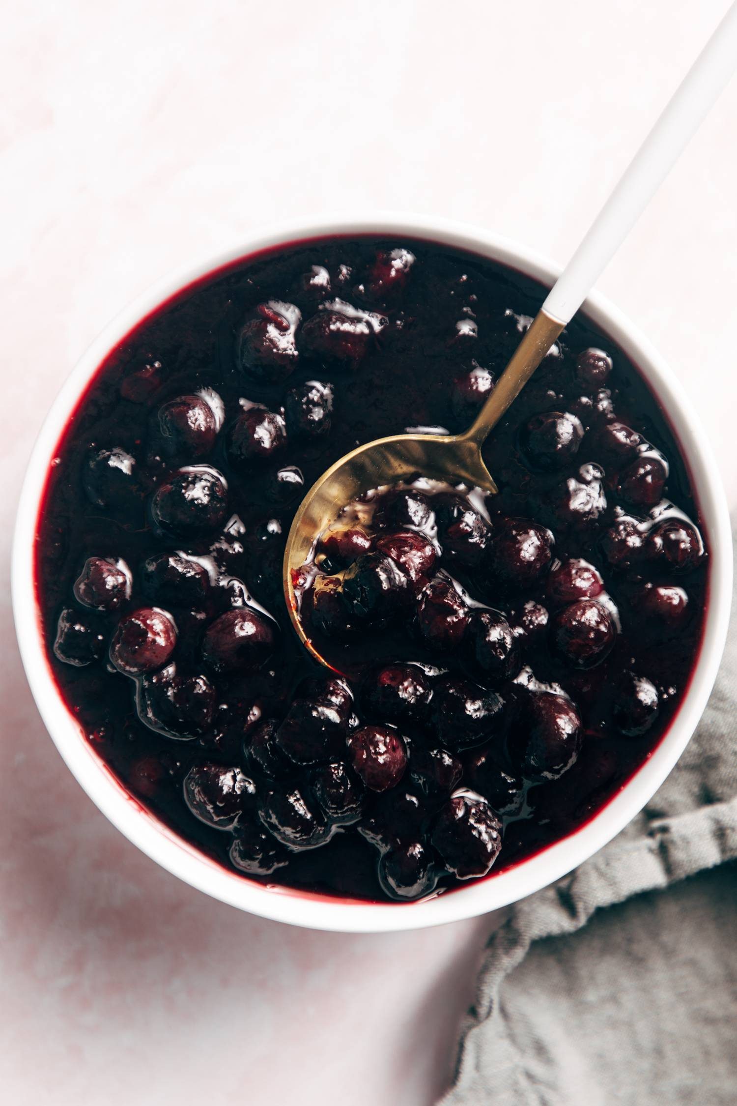 Blueberry sauce in a bowl with a spoon