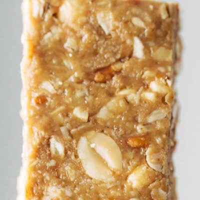 Granola bar being held by hand.
