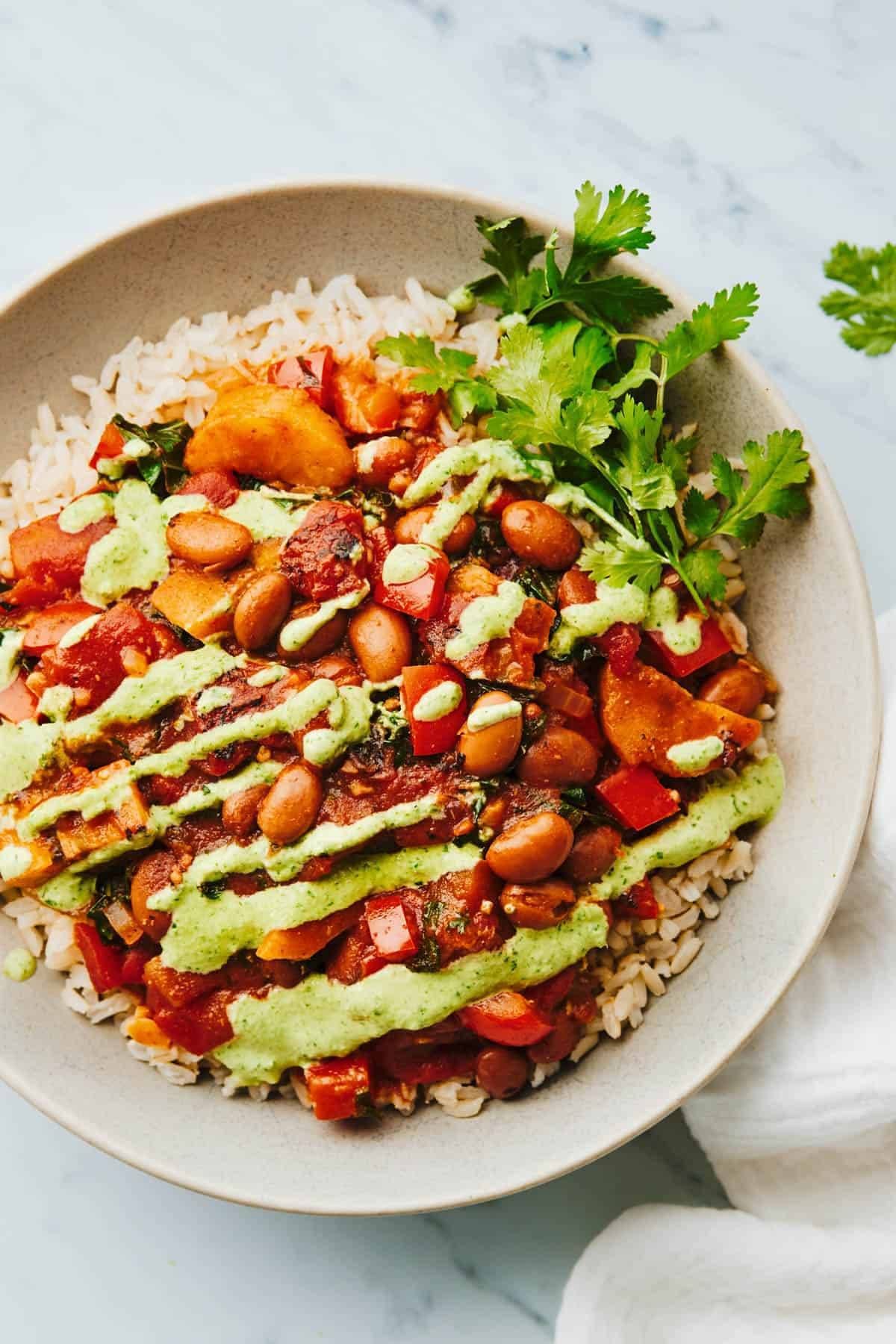 Plantain and pinto stew with aji verde on top.