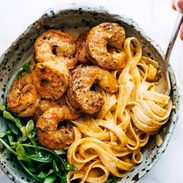 Red Pepper Fettuccine in a bowl with shrimp.