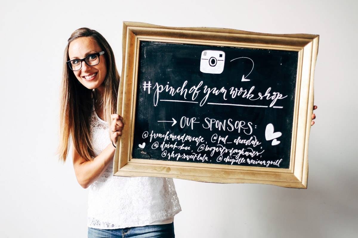 Woman holding a chalkboard sign.