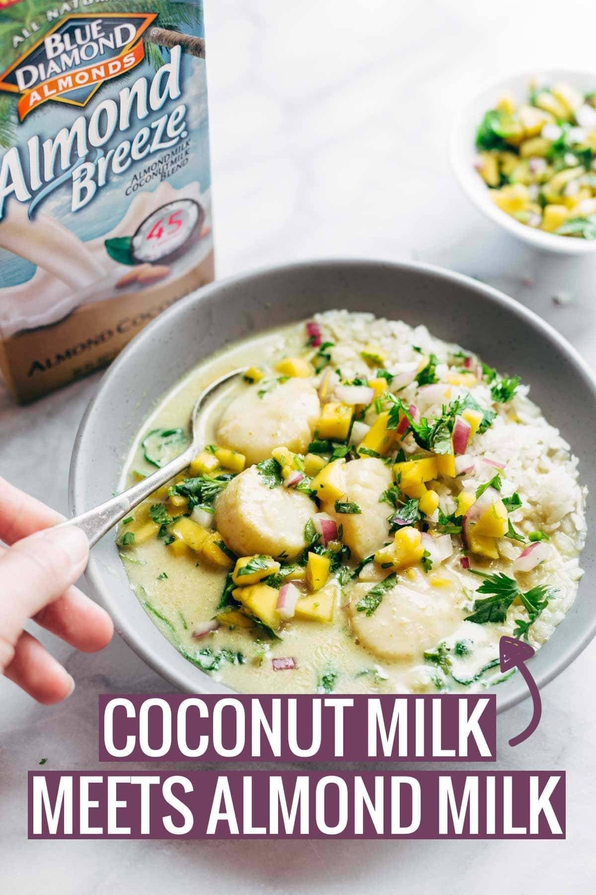 Scallops with mango cilantro salsa in a bowl with a spoon.