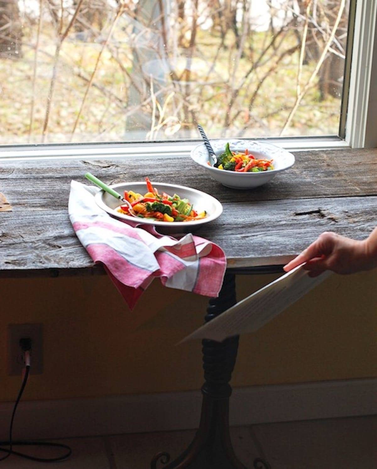 Bowls of food on a wooden surface.